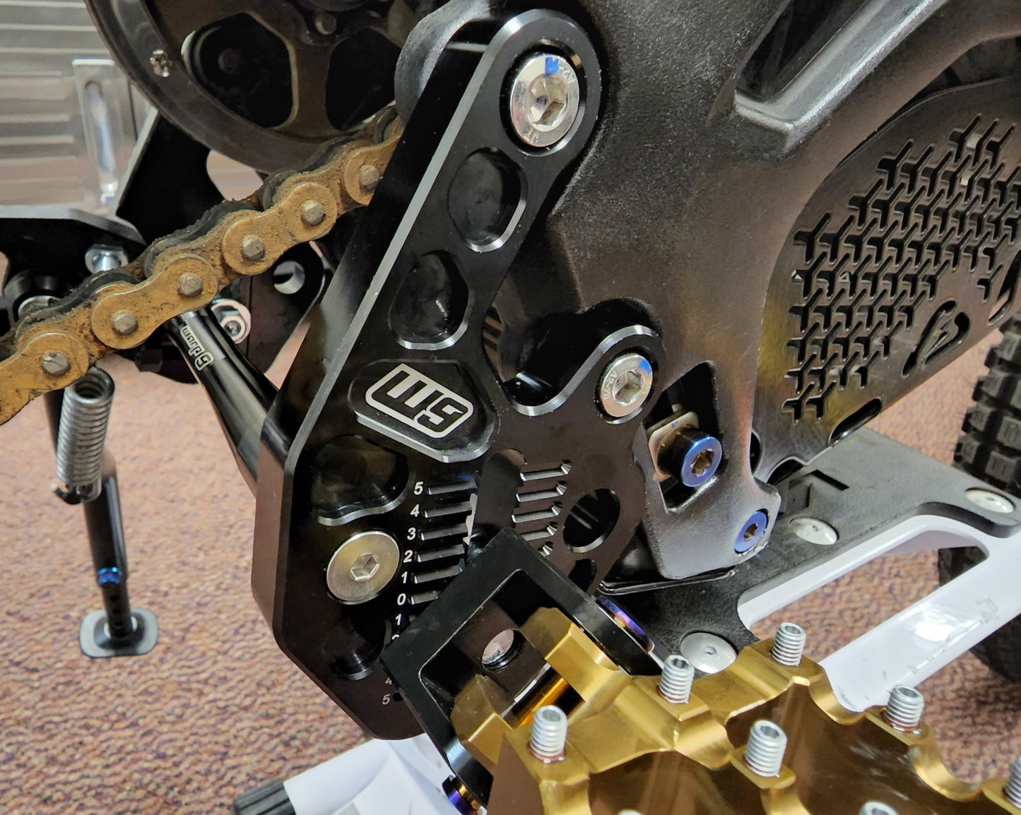 Warp9 Surron Adjustable Footpeg Bracket